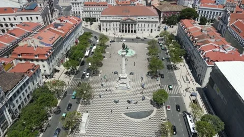 A drone camera flies around Dom Pedro IV Square in Lisbon Stock Footage 202016895