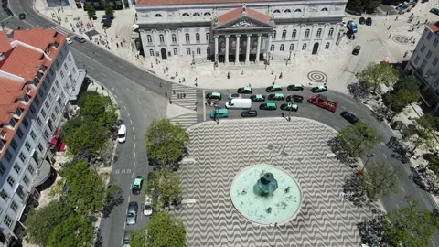 A drone camera flies backward over the Dom Pedro IV Square in Lisbon Stock Footage 202017234