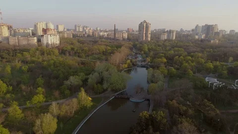 Drone camera flies backwards over the lake in Victory Park Stock Footage 74912758