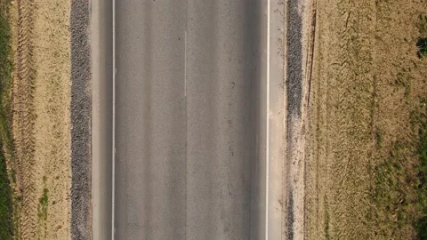Drone with camera flies over an asphalt highway, along which cars are passing Video stock 160375446