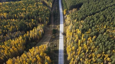 Drone with camera flies over highway on which cars are driving Stock Footage 318485595