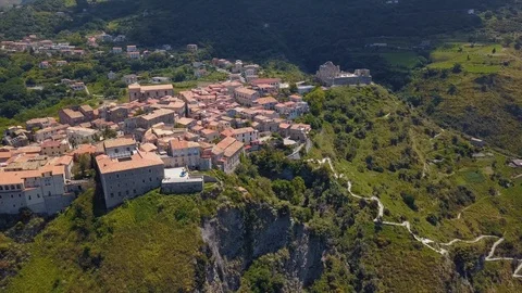 Drone camera flies over old masonry stone buildings with tile roofs, sunny day Stock Footage 111285087
