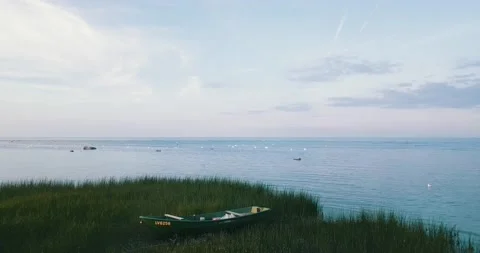A drone camera flies over the shallow waters of the sea bay along the coastline. Stock Footage 146702196