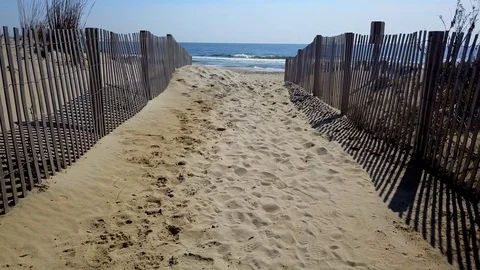 Drone camera flies sideways along beach sand dune in Ocean City, Maryland Stock Footage 89452081