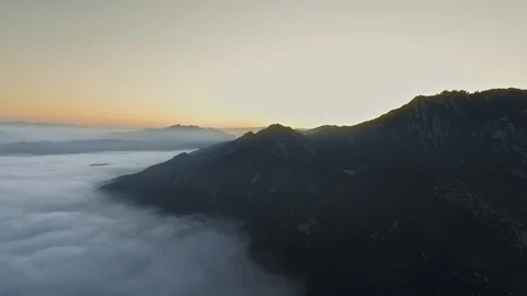 Drone camera flies through beautiful clouds and shoots the sun hidden behind the Stock Footage 126678494
