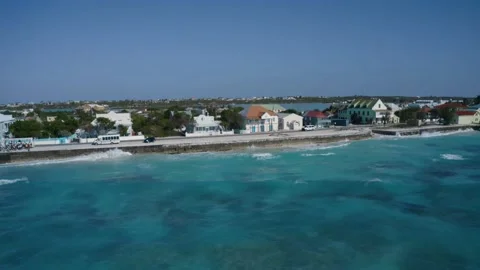 Drone camera fly off coastal area in Cockburn Town, Grand Turk, Turks and Caicos Video stock 194506449