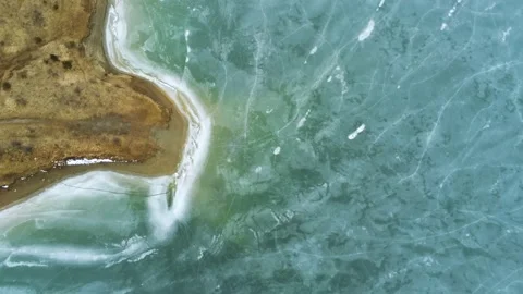 Drone camera flying backwards over beautiful frozen lake Stock Footage 149357342