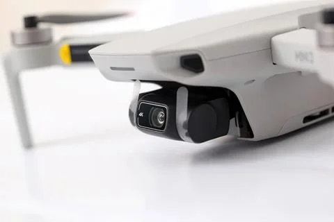 Drone with camera flying close up on white background Стоковые фото