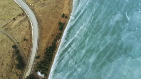 Drone camera flying over beautiful blue frozen crystal clean lake Stock Footage 149357338