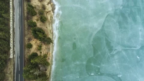 Drone camera flying over beautiful blue frozen crystal clean lake Stock Footage 149357352
