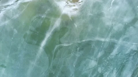 Drone camera flying over blue cracked ice Stock Footage 149357324