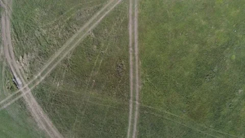 Drone camera flying over intersecting dirt roads Stock Footage 140037037