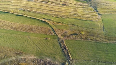 Drone camera flying over intersecting dirt roads Stock Footage 141531543