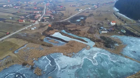 Drone camera flying over a  small frozen lake Stock Footage 149205125