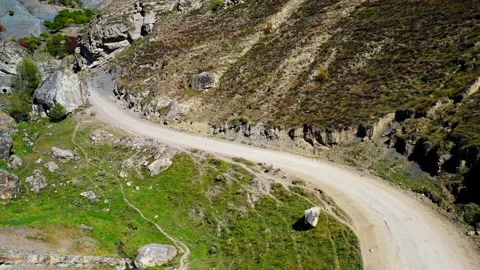 Drone camera follows a winding mountain road. Mountain path. Stock Footage 143926552