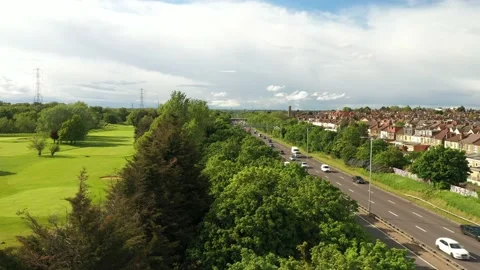 Drone camera footage from golf course over trees above rush multilane road Stock-Footage 155518959