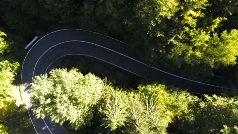 Drone camera landing over a curving asphalt road Stock Footage 162117262