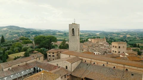 A drone camera moves around the circumference of one of the towers of San Stock Footage 308538641