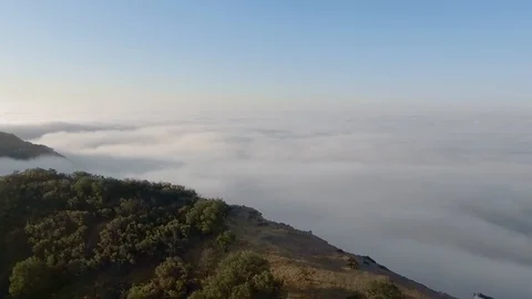 The drone camera moves from the cliff of the canyon into endless thick clouds Stock-Footage 126679165