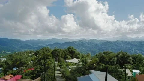 Drone camera moves over the settlement to the cliff (Saint Lucia) Stock Footage 131563932