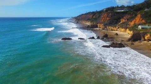 Drone camera moving over sandy shore at sunny day near El Matador Beach, Malibu Stock Footage 137405228