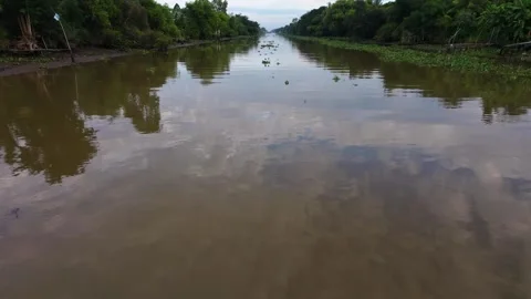 Drone camera pitch down showing muddy alluvial water surface of rural river Stock-Footage 342924459