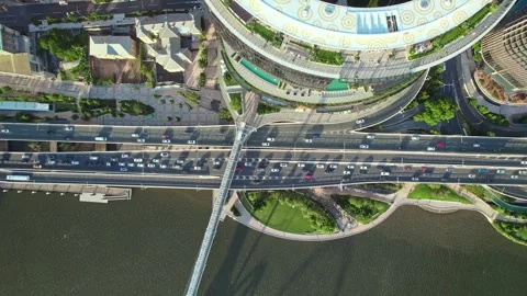 A drone camera points downward to capture a vibrant urban scene - a busy highway Video stock 306125288