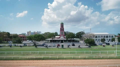 Drone camera receding from the red chapel at Garrison Savannah racecourse Video stock 136389588