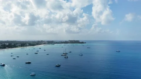 Drone camera rises above yachts in a calm blue sea near Bridgetown, Barbados Video stock 136384806