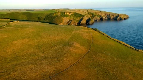 Drone camera rises over stunning headland in Cornwall Stock Footage 95827600