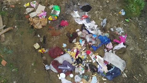 Drone camera rising above human trash Stock Footage 138739879