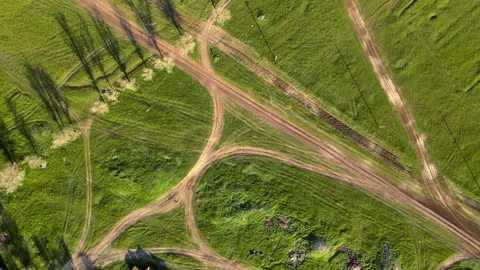 Drone with camera rotates, rising above the ground. Green fields dotted with Stock Footage 160698214