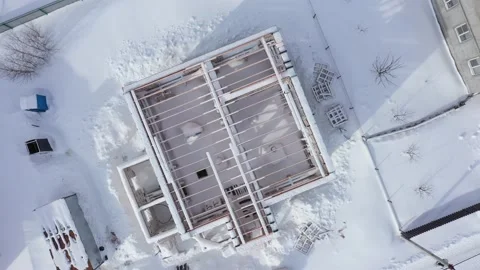 Drone camera rotating over unfinished house in snow Video stock 155660771