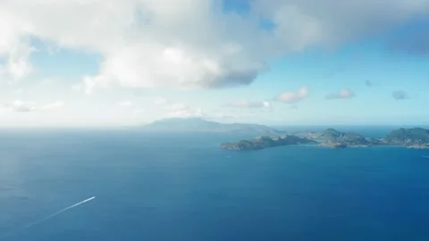 Drone camera shot of two yachts heading towards a hilly island Video stock 136405674