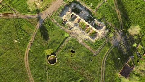 Drone with camera slowly descends over an old ruined building, in which only Video stock 162931726