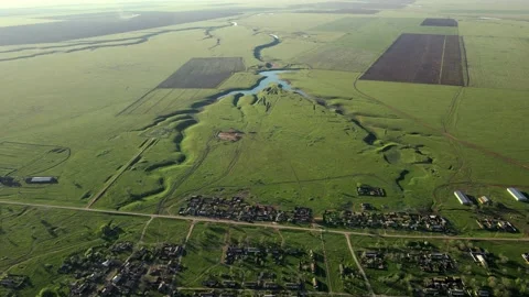 Drone with camera slowly flies over rural area with quiet village, asphalt roads Stock Footage 160059780