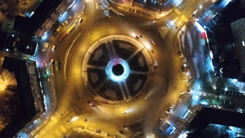 Drone camera spin around crossroads night city. Nightlife road with yellow light Stock Footage 100740958