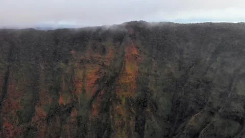 Drone camera takes off over a high mountain range under the clouds in Kauai Video stock 138237796