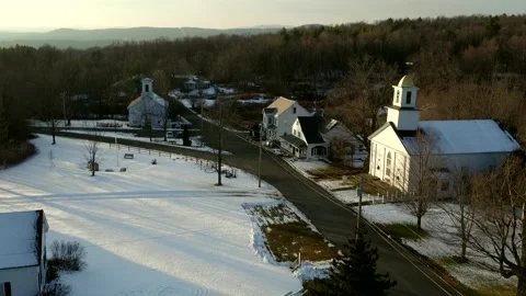 A Drone Camera Tilts Down Then Rises Over A Small Snow Covered Town Stock Footage 329901474
