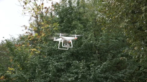 Drone with camera while flying in the forest. Unmanned aerial copter flight. Stock Footage 68298088