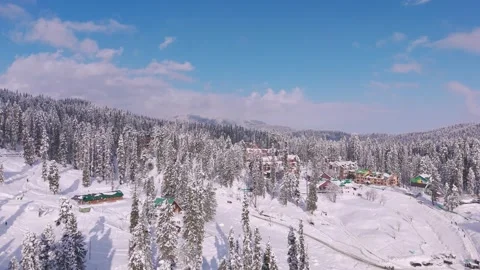 Drone capture of alpine buildings glowing in a white wonderland. Stock Footage 311945971