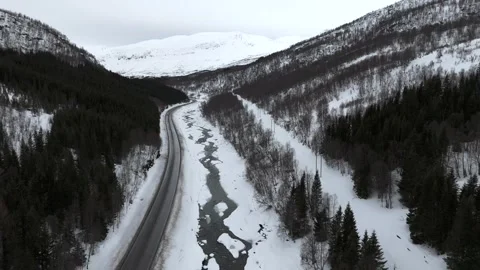 Drone captured aerial view of a snowy Nordic landscape in Norway, featuring a Stock Footage 330376541