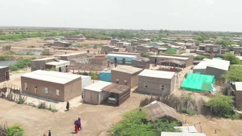 Drone captured an aerial view of a tiny village with several square shaped Stock Footage 208086706