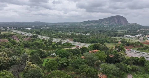 A drone captured view of Bangalore to mysore highway surrounded by greenery Stock Footage 325952134