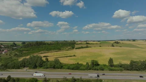 Drone captures autobahn traffic from left to right on a bright summer day in Stock Footage 264187867