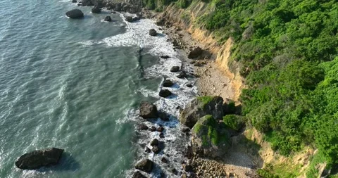 A drone captures a breathtaking aerial view of the ocean and picturesque moun Video stock 245465464