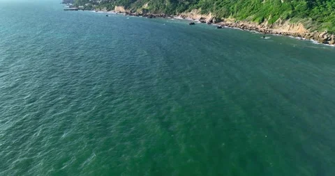 A drone captures a breathtaking aerial view of the ocean and picturesque moun Video stock 245465782