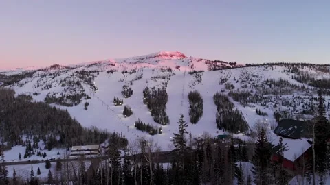Drone captures Brians Head Ski Resort after sunset with snowboarders and skiers. Stock Footage 142333593
