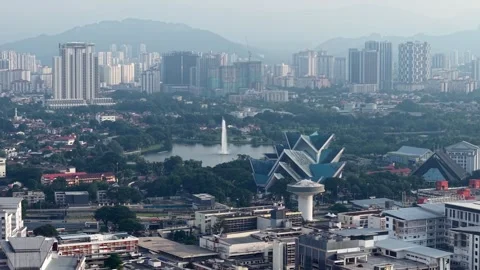 Drone captures the calm streets and glowing rooftops of early morning. 스톡 동영상 318094345