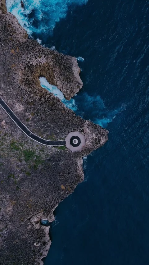 Drone Captures Curving Coastal Path Above Vibrant Turquoise Waters Stock Footage 324828174